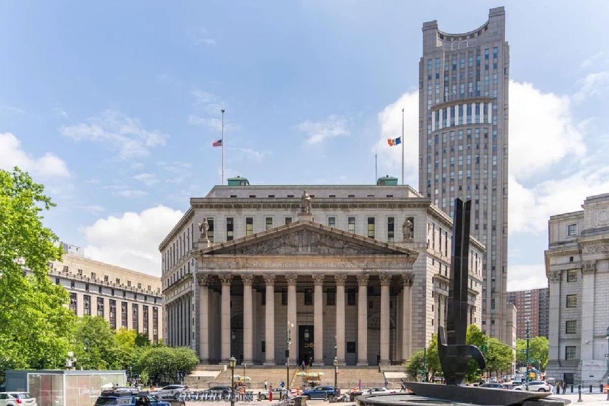 View of the historic New York County Courthouse with clear skies and cityscape.
