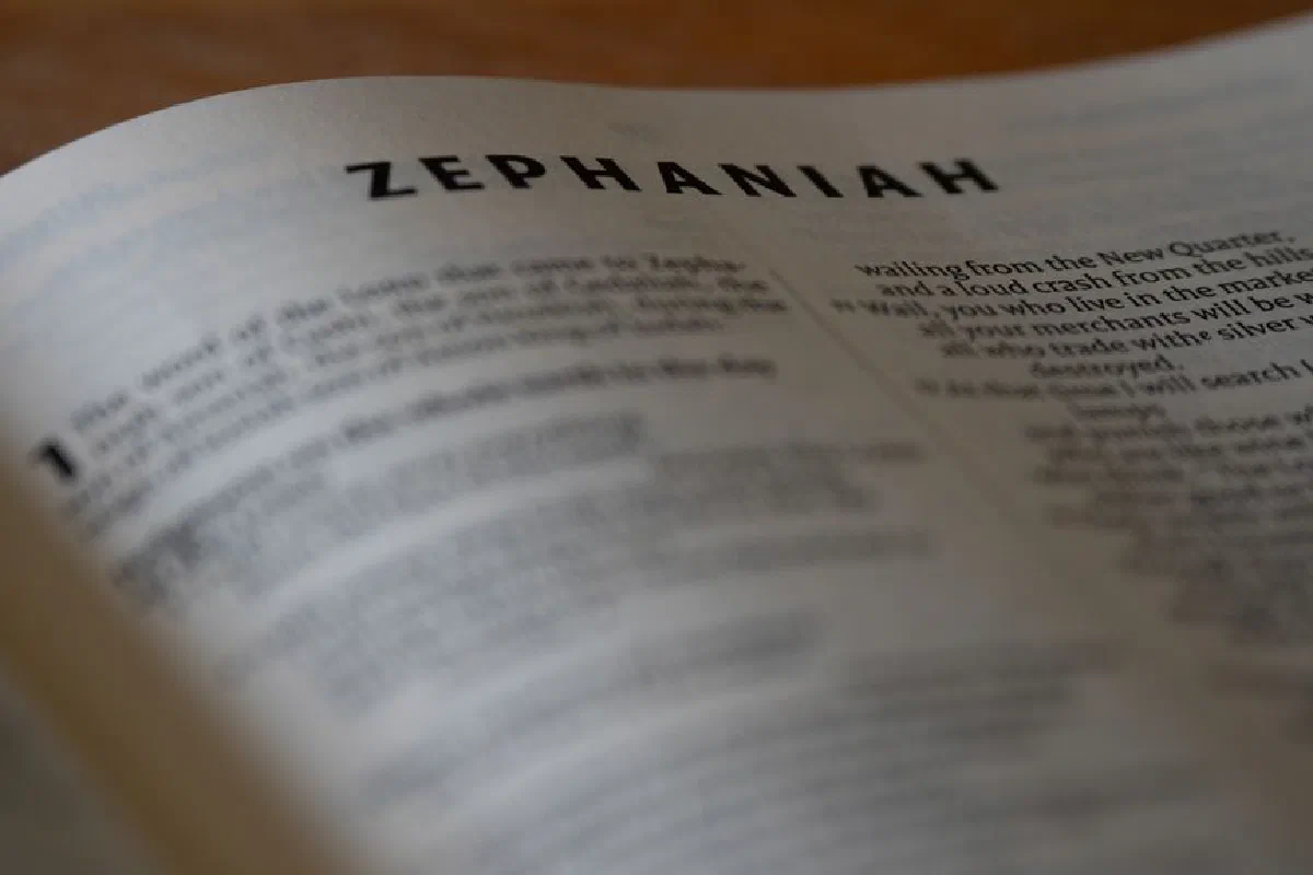 Close-up of an open Bible page highlighting the book of Zephaniah with selective focus.