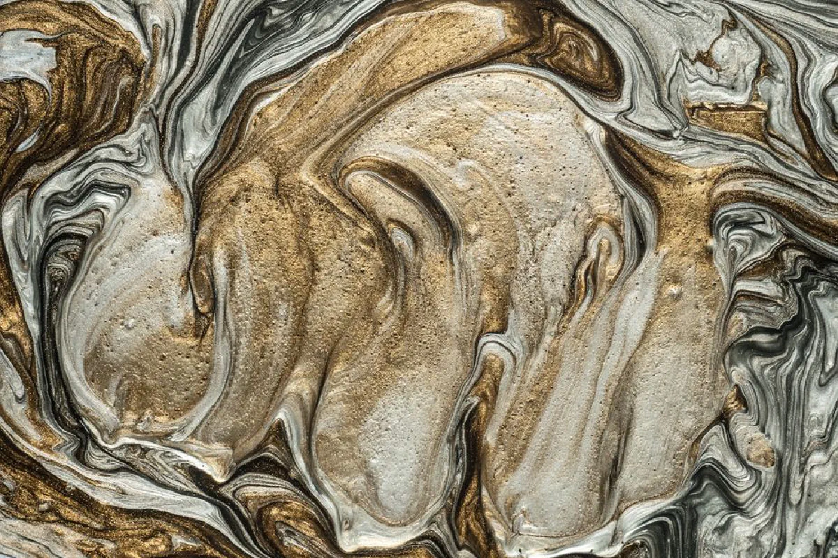 Elegant marbled art pattern with swirling golden and silver hues. Perfect for abstract art lovers.