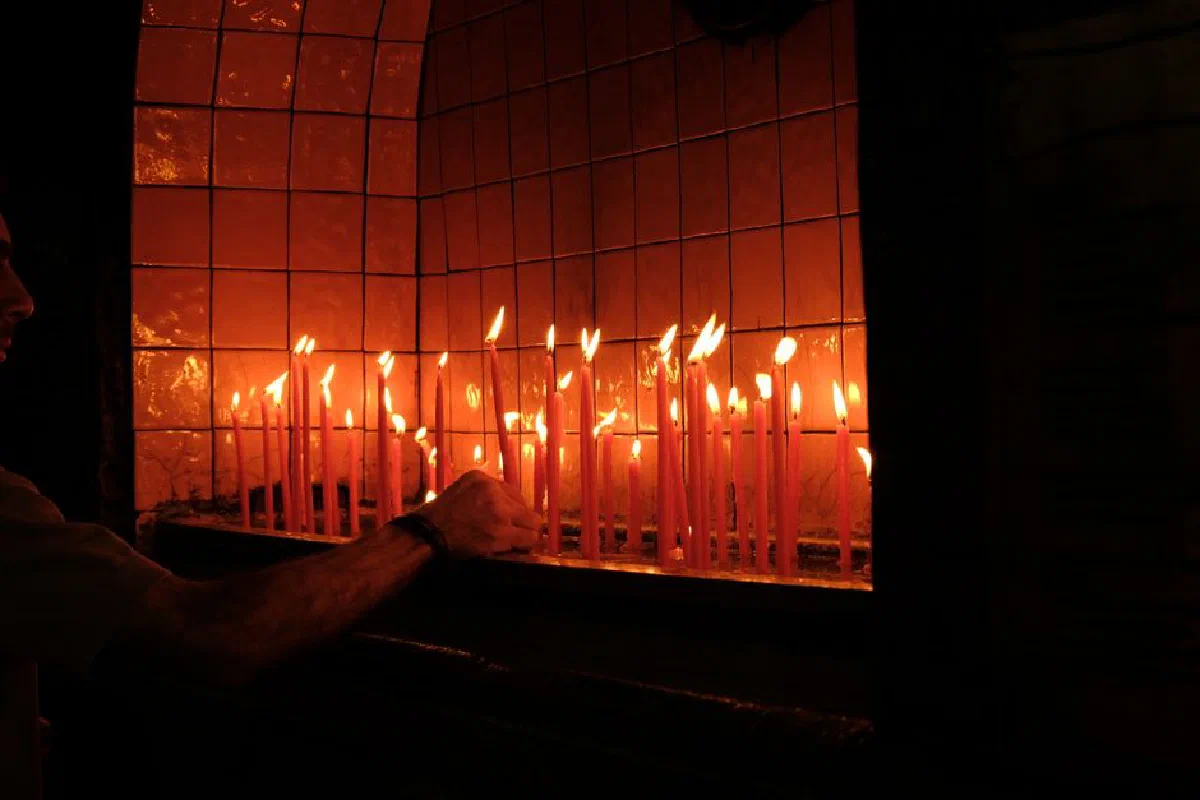 A serene scene of lit candles creating a warm glow, perfect for spiritual and peaceful settings.