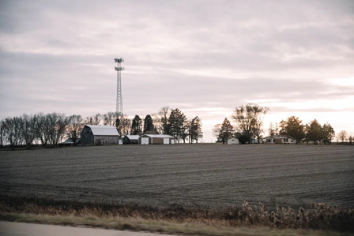 A serene rural farm landscape at sunrise featuring fields and a distant cabin in Dixon, Illinois.