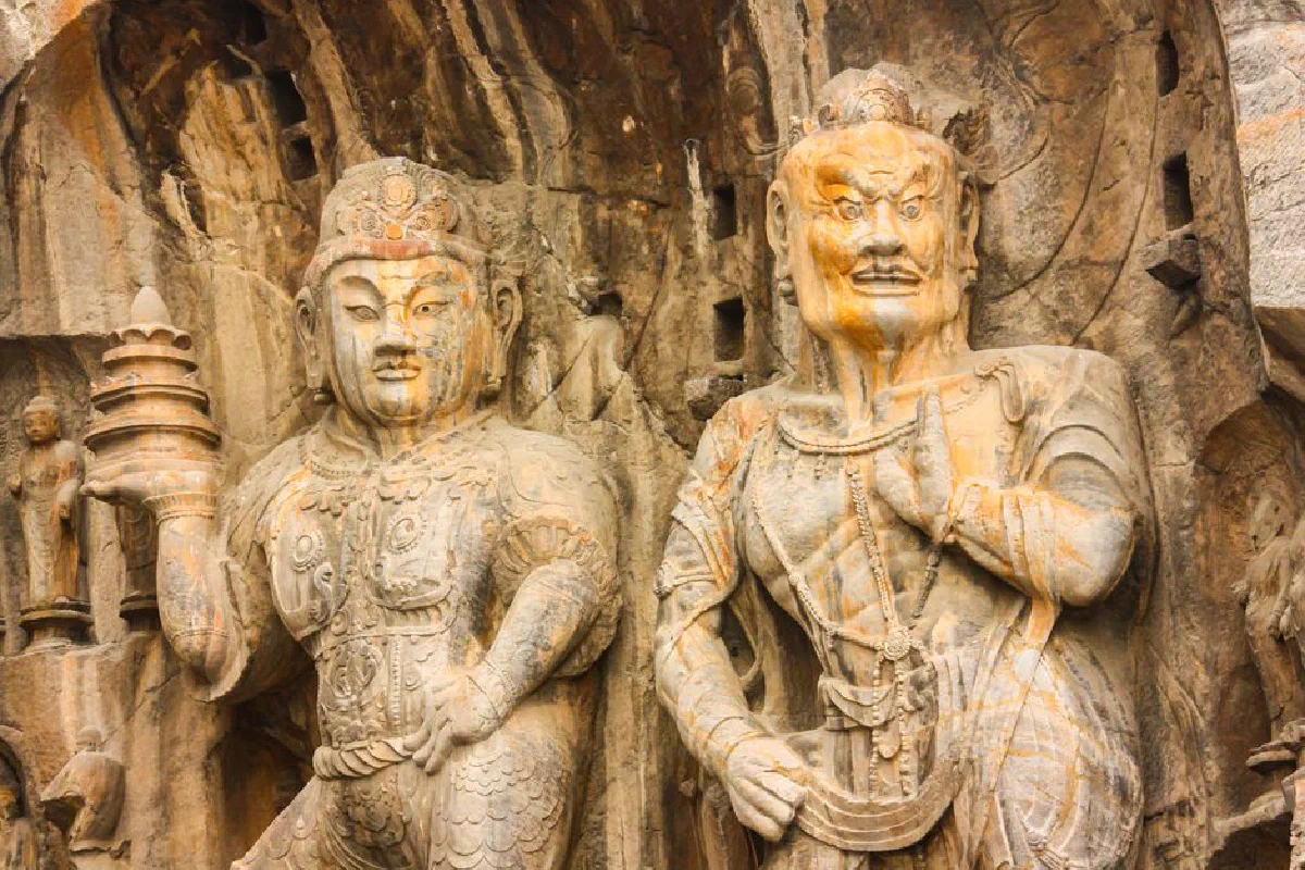Detailed view of ancient Buddhist sculptures at the Longmen Grottoes in Luoyang, China.