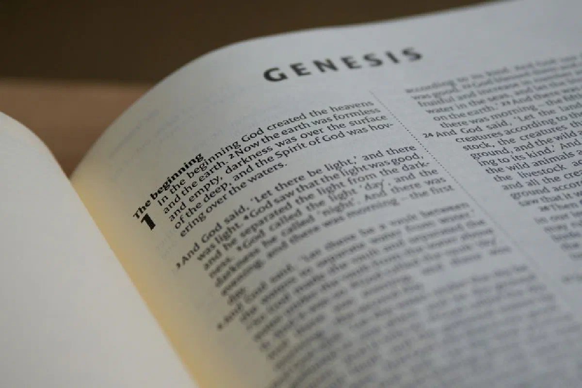Detailed view of the Book of Genesis in a Bible with selective focus accentuating the text.