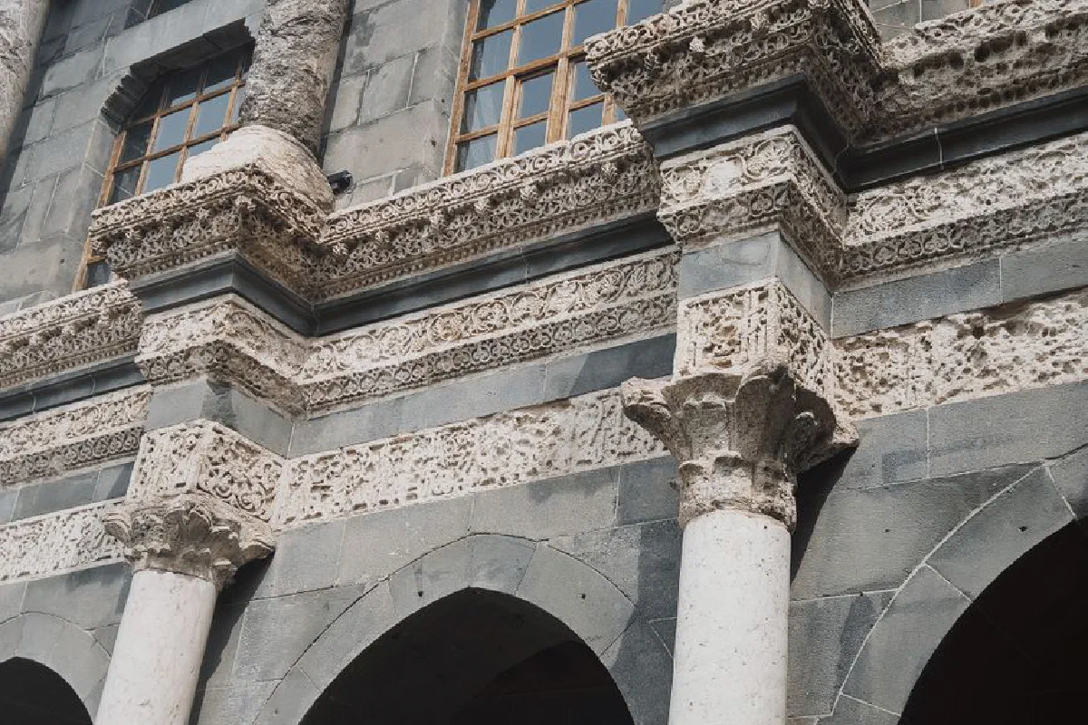 Intricate stone carvings and ornate columns in historic architectural facade. Ideal for themes of history and heritage.