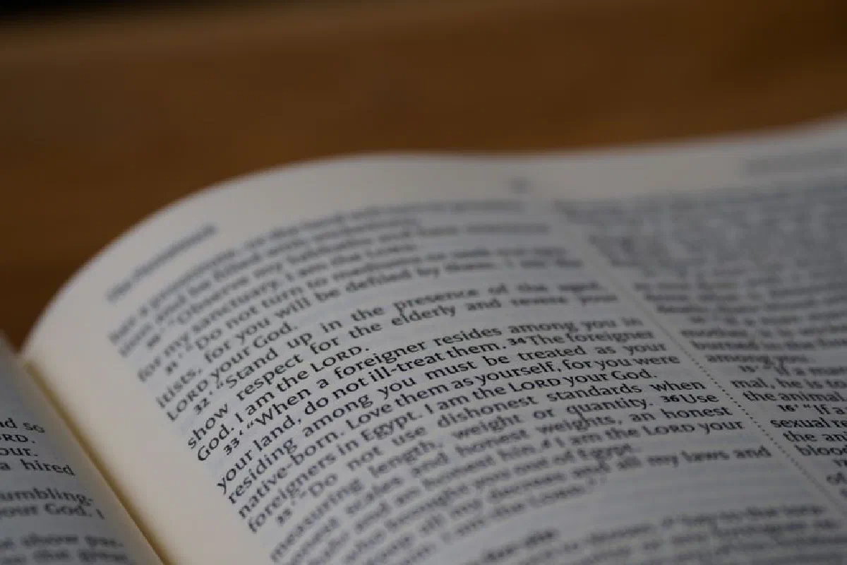 Selective focus on text in an open Bible highlighting scripture study and Christian faith.