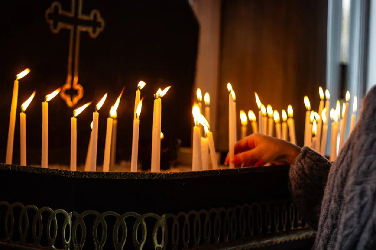 A reflective moment with lit candles inside a church, conveying warmth and spirituality.