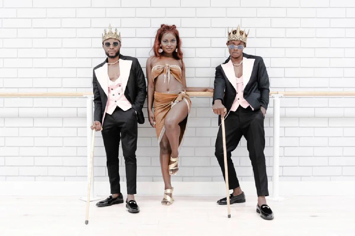Stylish group in royal-themed outfits posing confidently indoors.