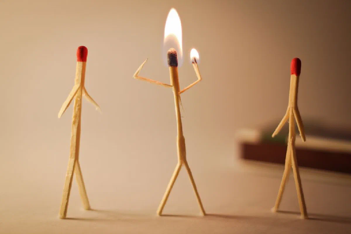 Artistic matchstick figures arranged with flames showcasing creativity and craftsmanship.