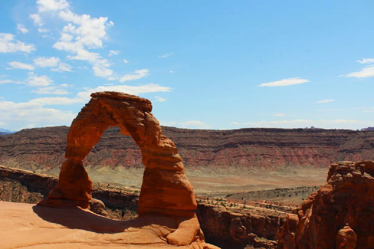 Stunning view of Delicate Arch under a vibrant blue sky in Moab, Utah. Perfect for outdoor enthusiasts.