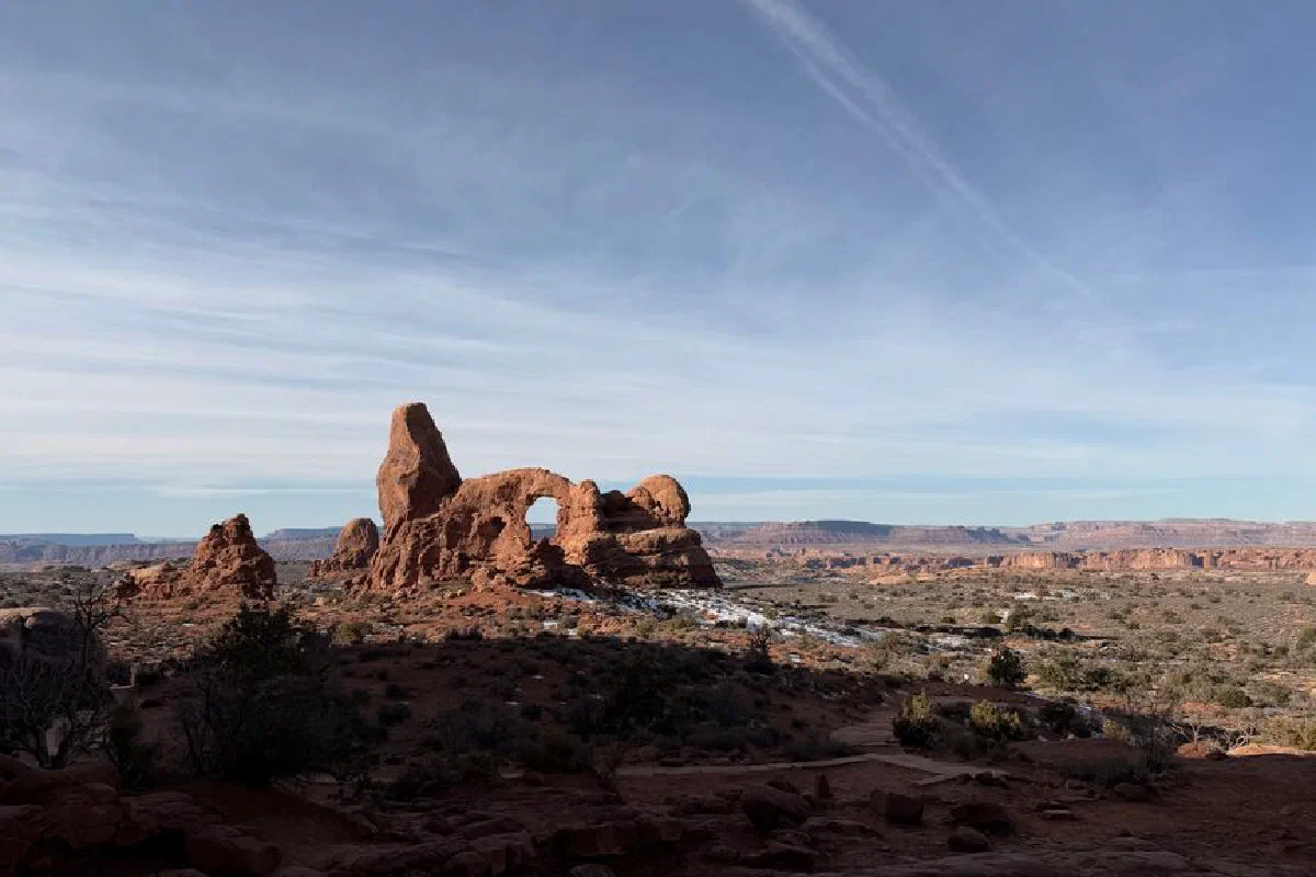 Explore the breathtaking rock formations at Arches National Park under a clear blue sky.