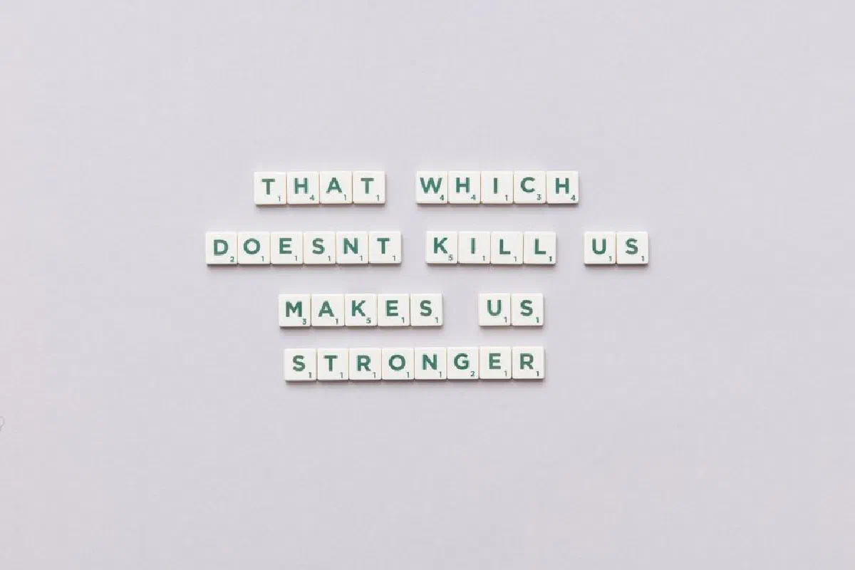 Inspirational quote using Scrabble tiles on a light background, perfect for motivational content.
