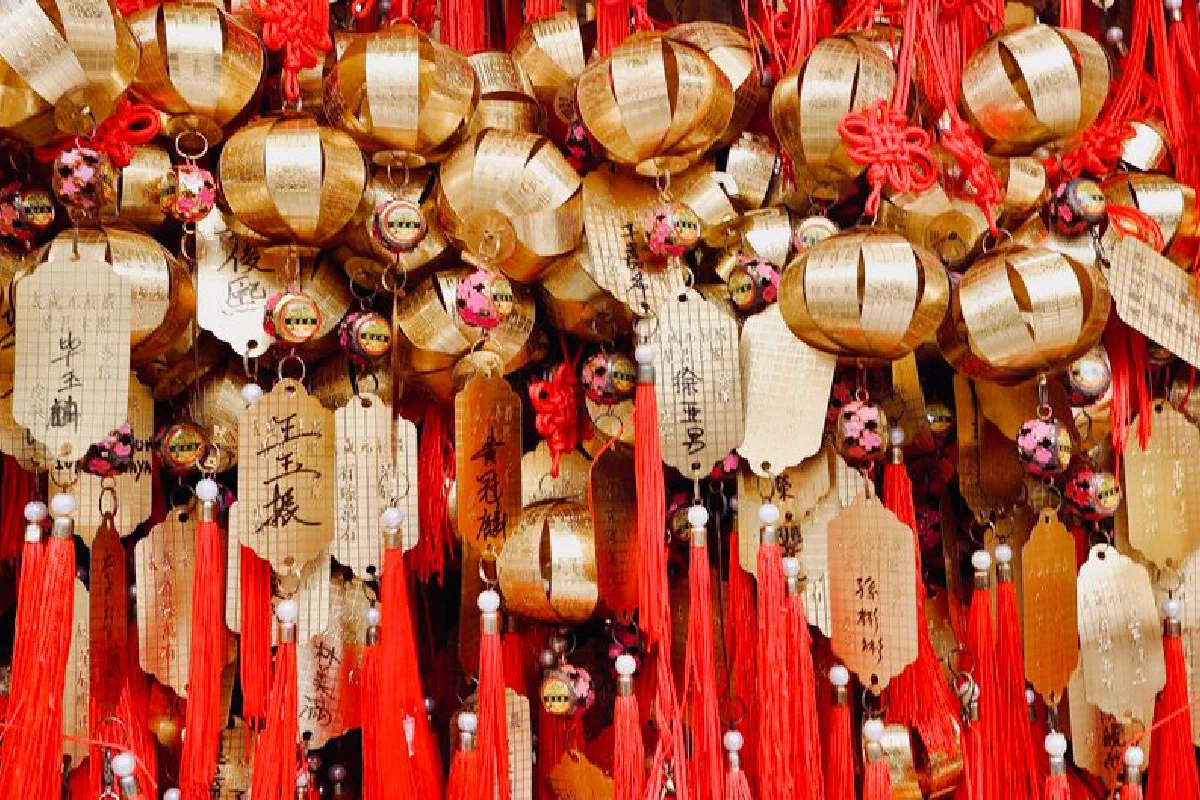 Close-up of golden temple ornaments and red tassels at Wong Tai Sin Temple in Kowloon, Hong Kong.
