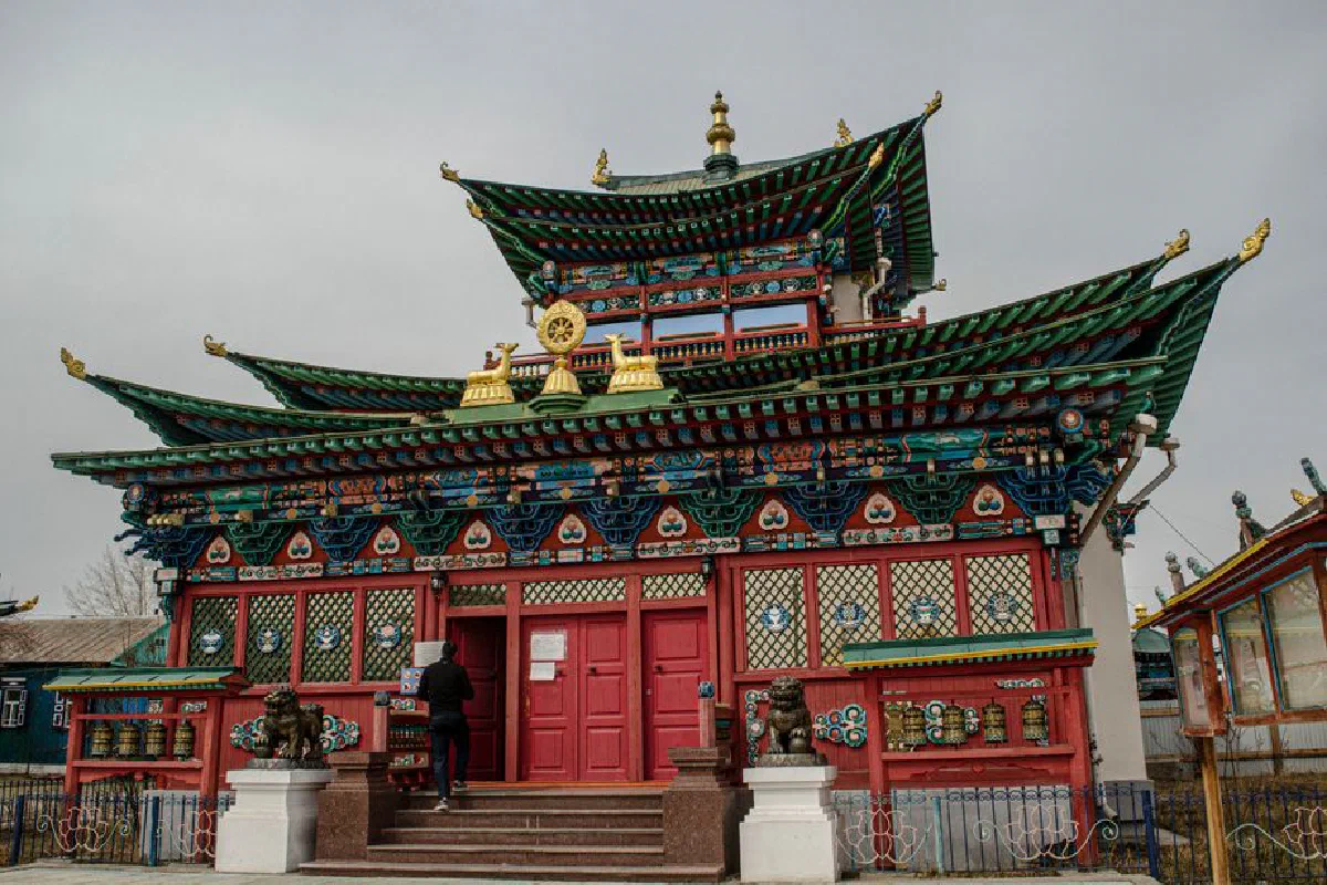 A traditional temple with intricate architecture and vibrant colors, under a cloudy sky.