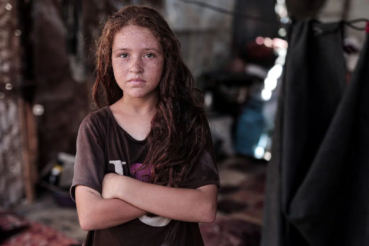 Portrait of a young girl in Gaza, showing determination amidst a challenging environment.