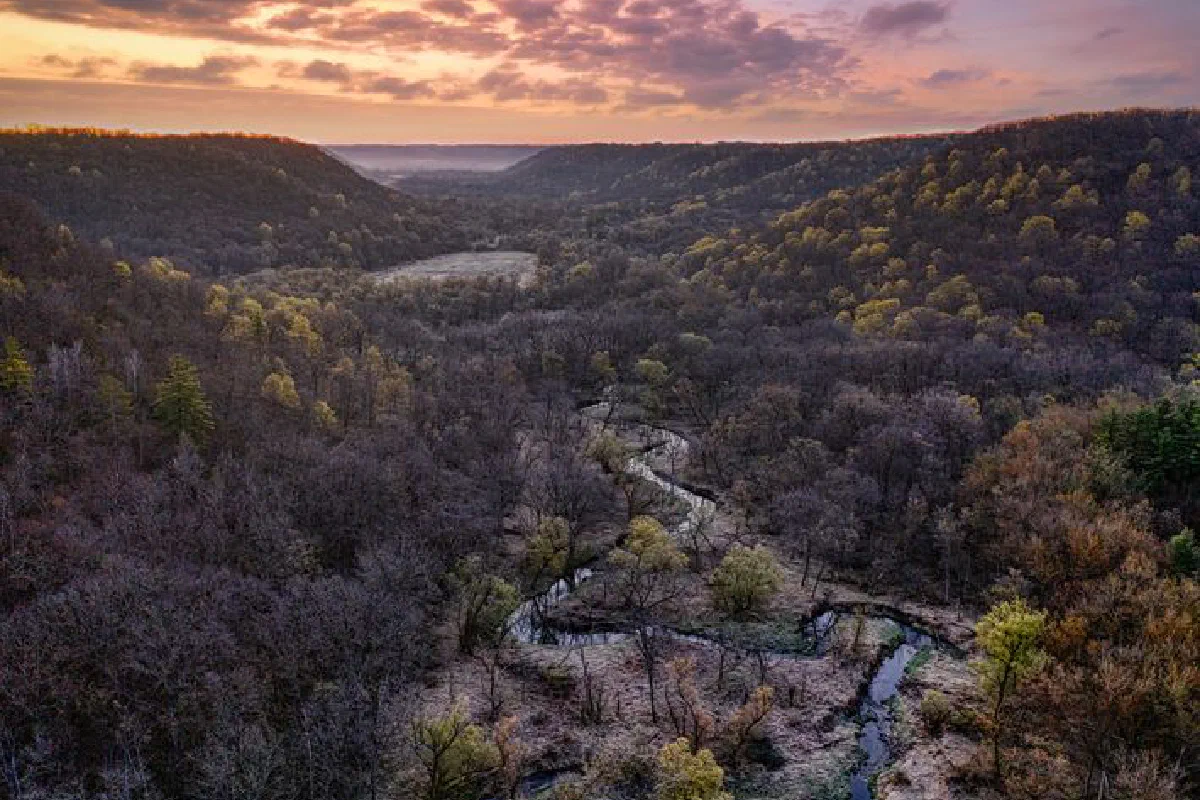 Aerial capture of a scenic valley in Minnesota with vibrant sunset hues.