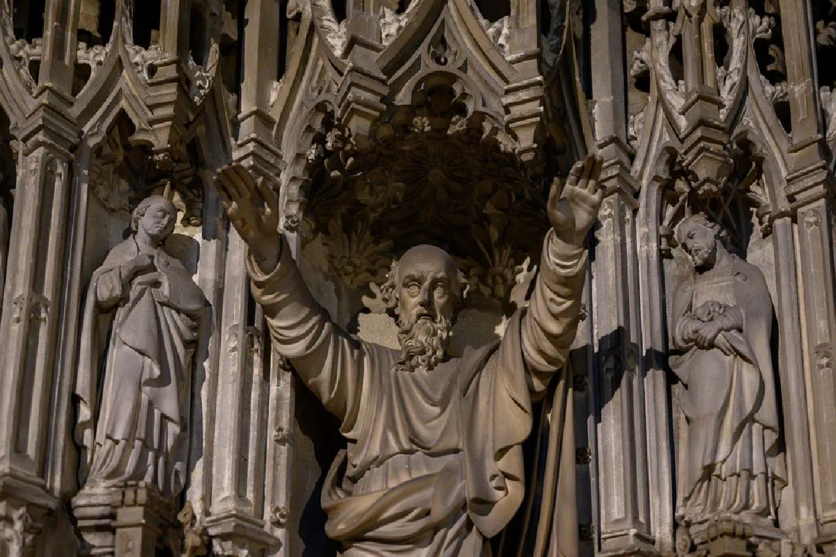 Detailed view of intricate Gothic stone statues inside an English cathedral, showcasing historical artistry.
