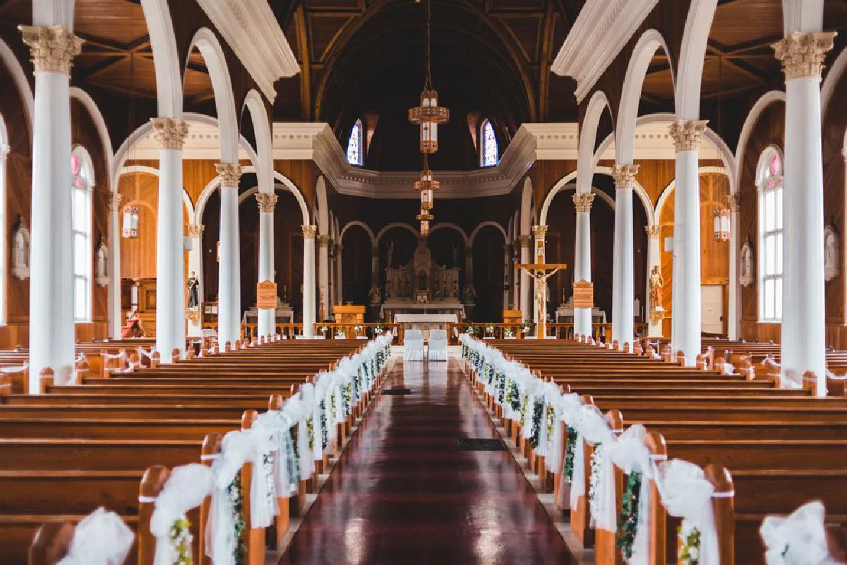 Elegant view of a church interior with decorated pews and arches, highlighting its architectural beauty.