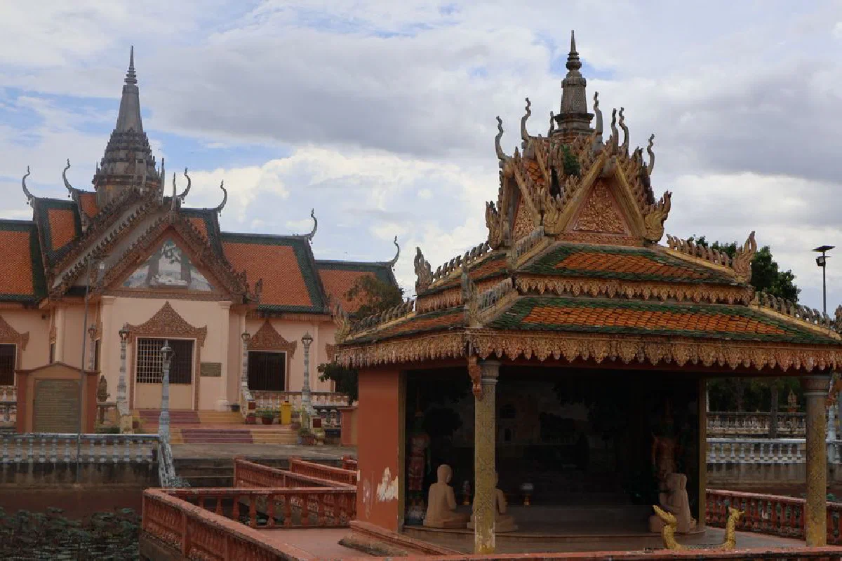 A beautifully crafted Cambodian temple with intricate roof designs and peaceful surroundings.