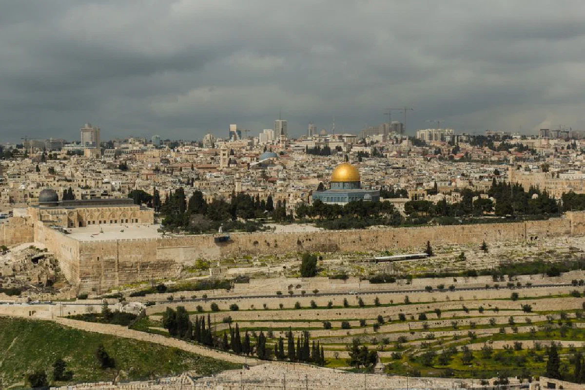 A stunning view of Jerusalem's Old City featuring the Dome of the Rock under a cloudy sky.