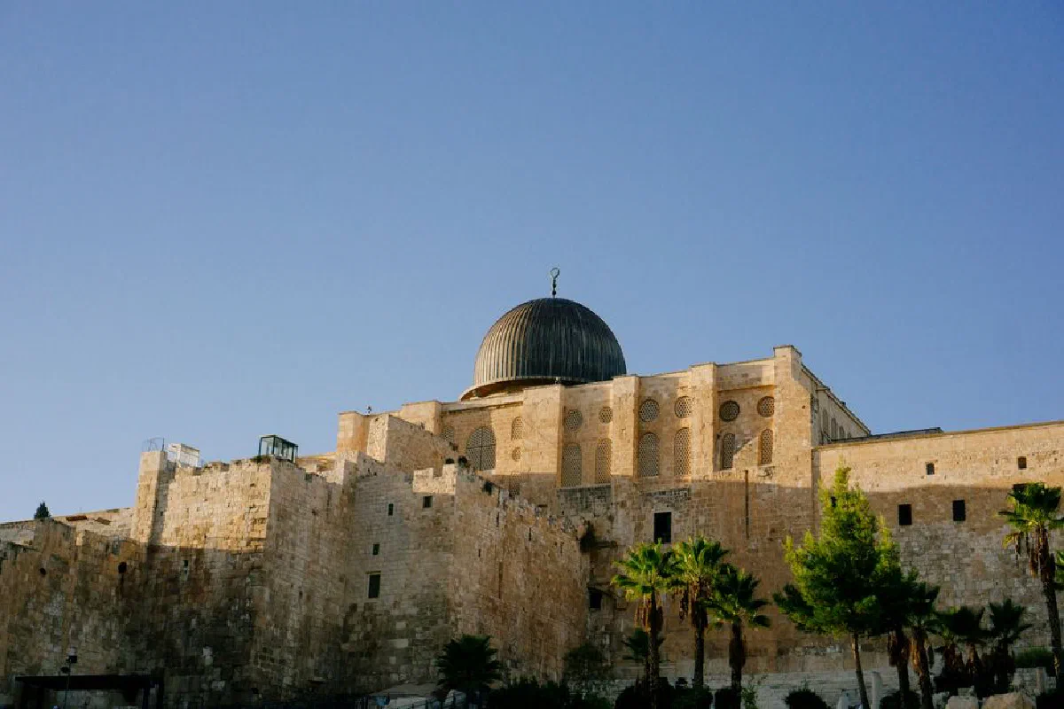 Al-Aqsa Mosque in Jerusalem, showcasing historic Islamic architecture against a clear sky.