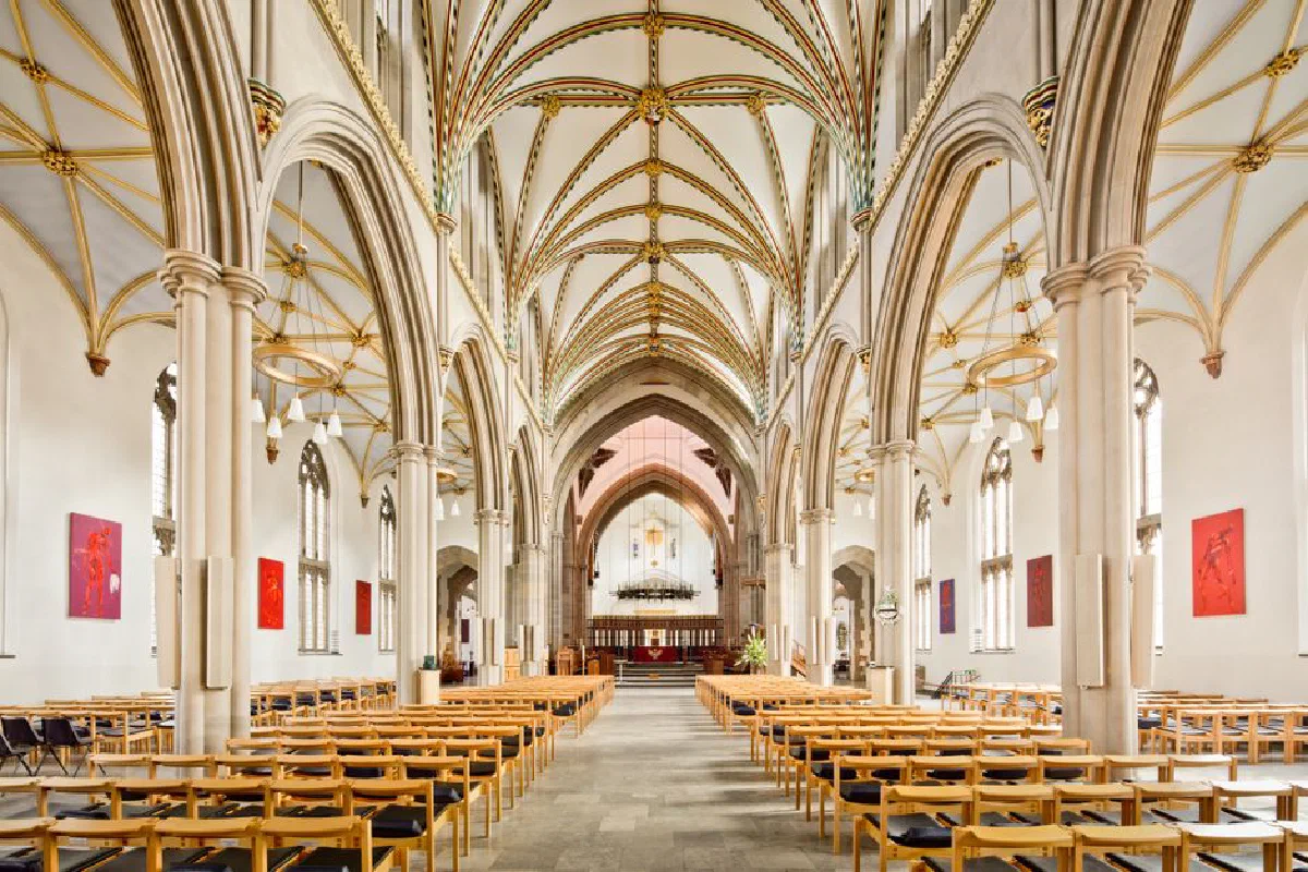 Stunning view of Blackburn Cathedral's gothic interior featuring ornate arches and empty pews.