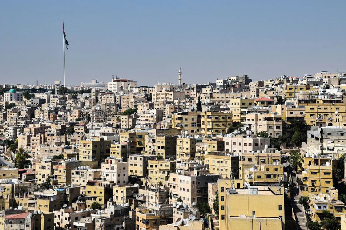 Explore a dense urban landscape of Amman with iconic architecture and a vast skyline.