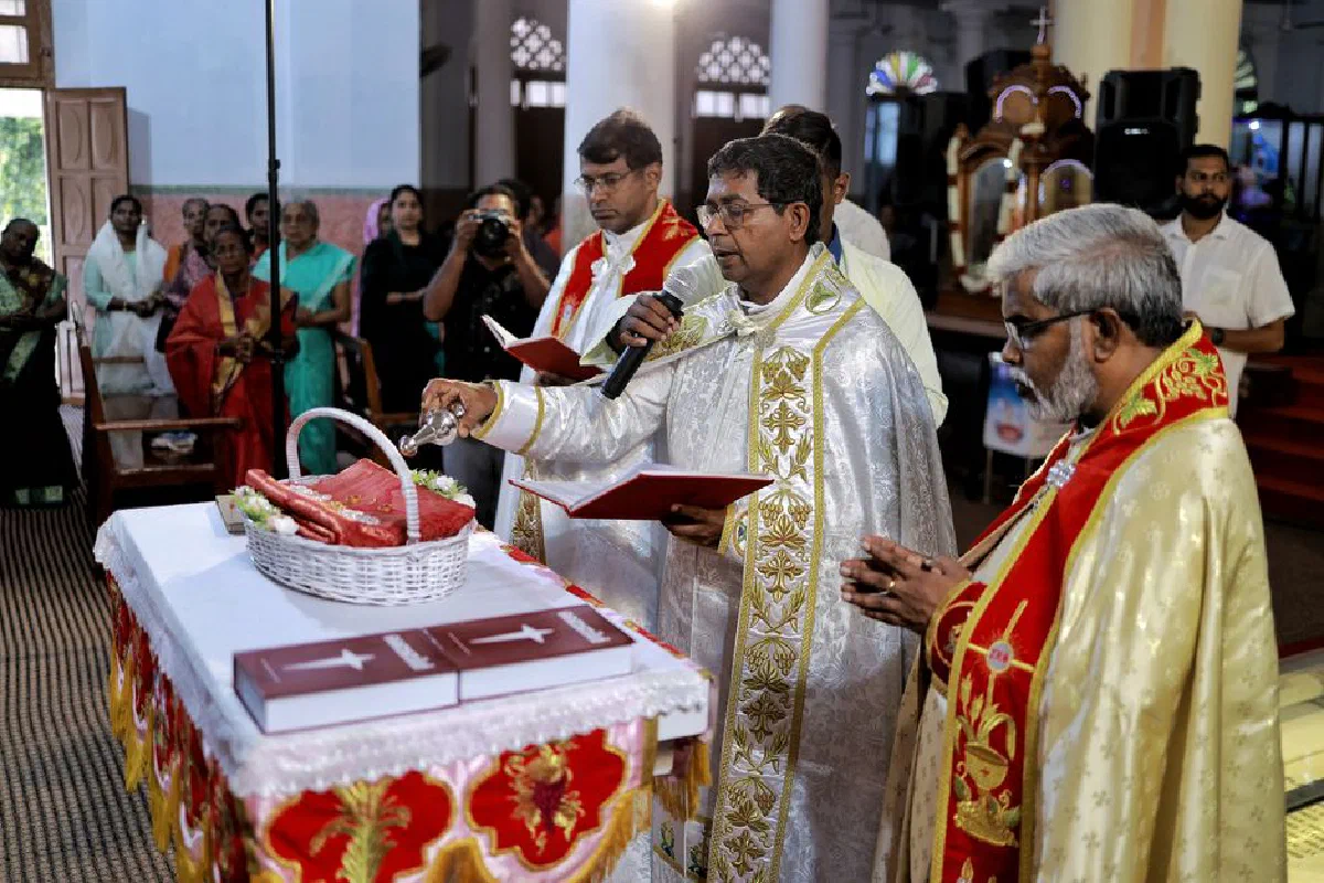 A vibrant South Asian Christian wedding ceremony with priests and guests in traditional attire.