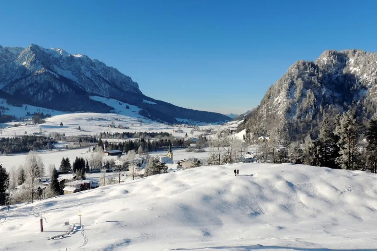 Picturesque winter view of snow-covered Walchsee, Tirol with majestic mountains.