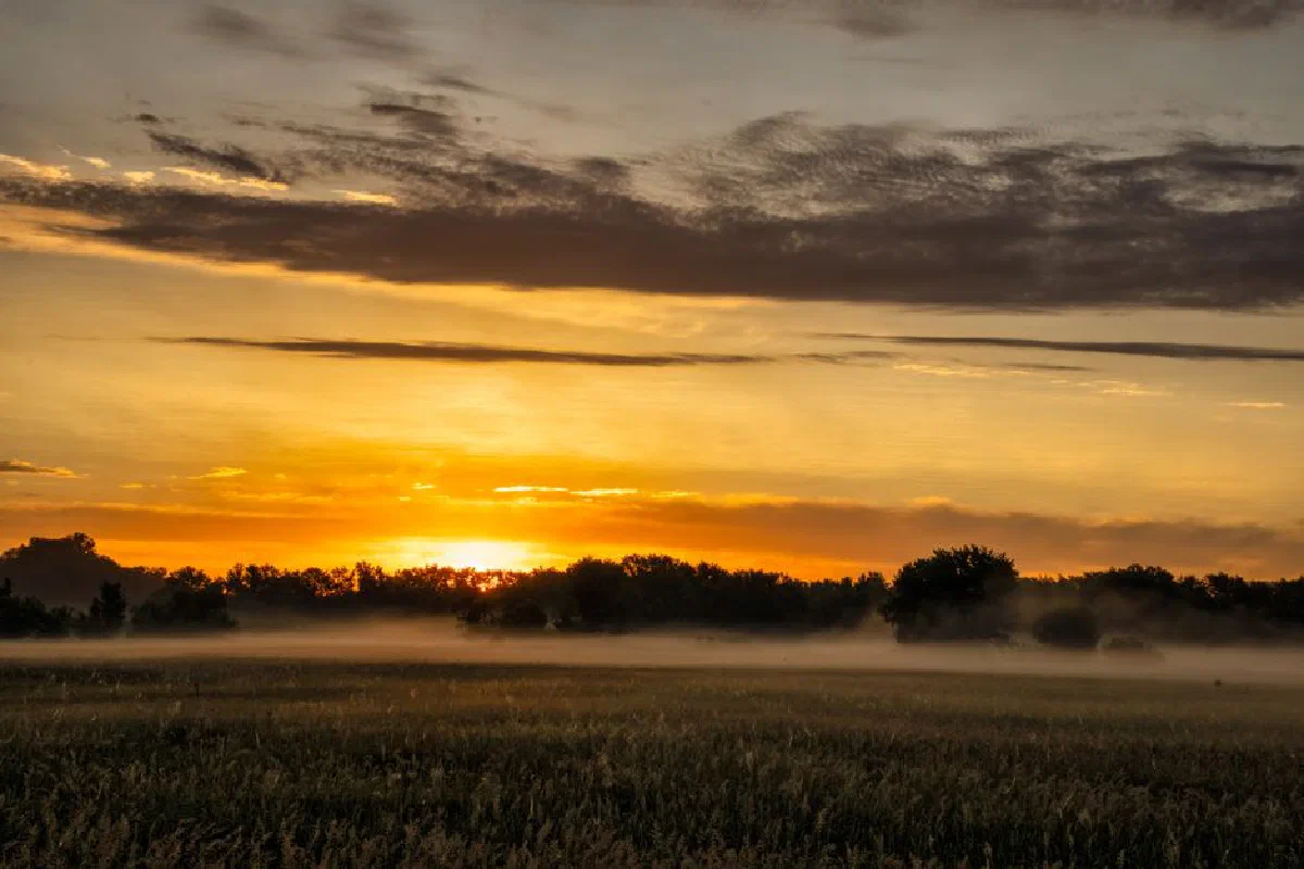 A breathtaking sunset over misty fields in Modena, Wisconsin. Perfect for serene countryside themes.