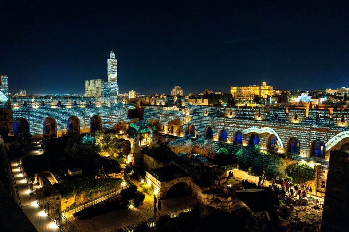 Spectacular night view of the Tower of David in Jerusalem, illuminated by vibrant projections.