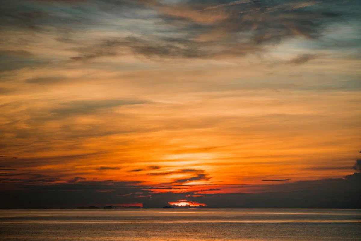 A breathtaking sunset over the ocean with vibrant orange and blue hues.