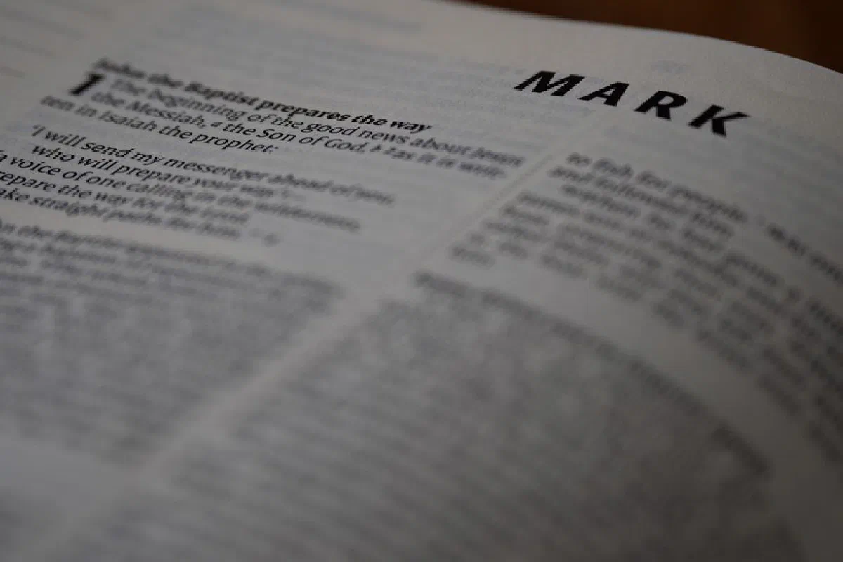 Open Bible showing text of the Gospel of Mark with a focus on religious scripture.