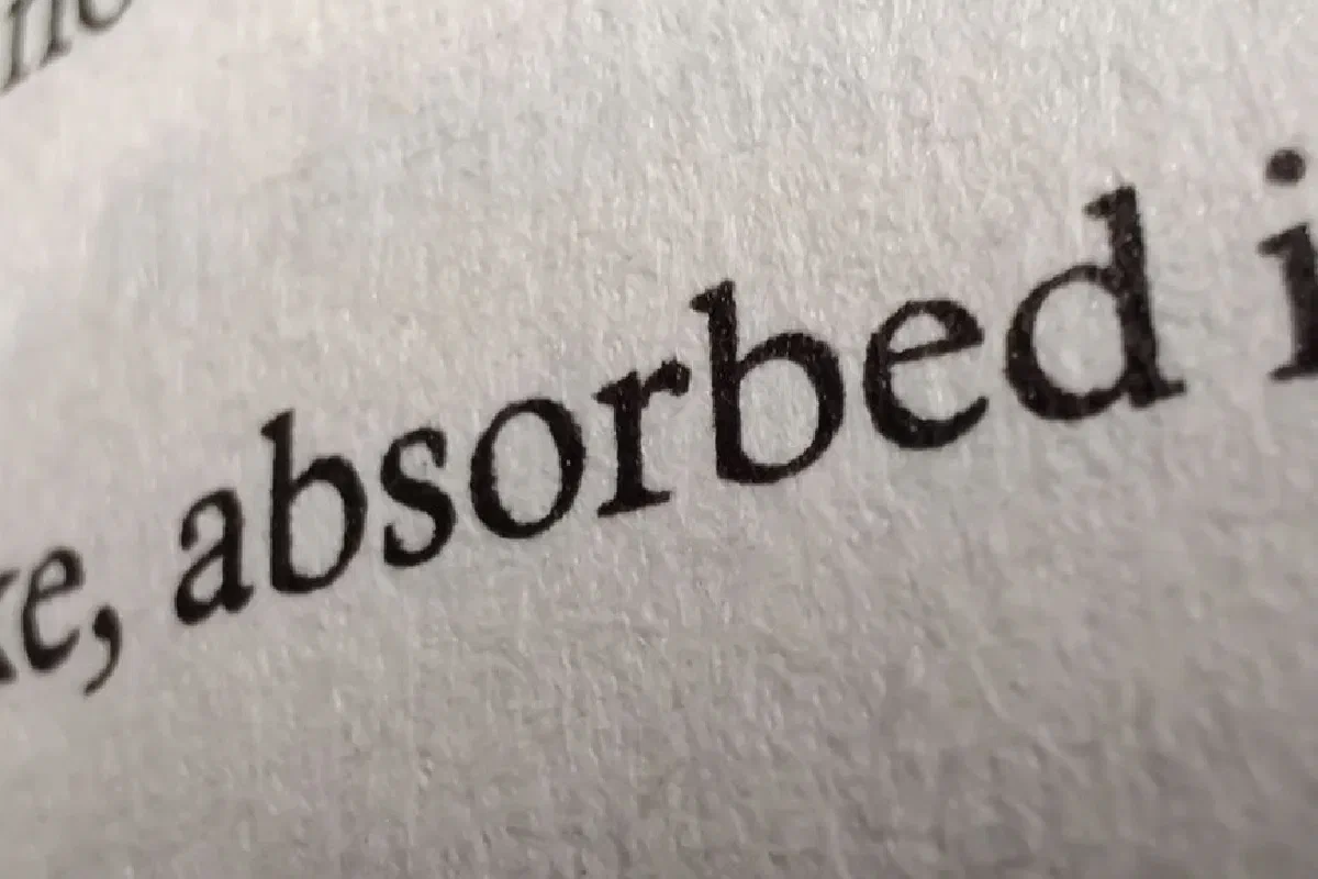 Detailed close-up image of printed text on a textured paper page.