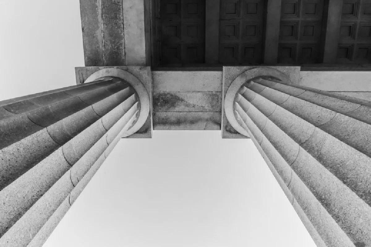 Black and white photo showcasing elegant architectural columns at Melbourne's Shrine of Remembrance.