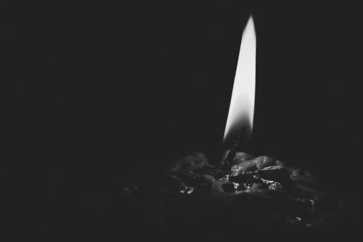 A captivating black and white close-up of a candle's burning flame casting shadows.