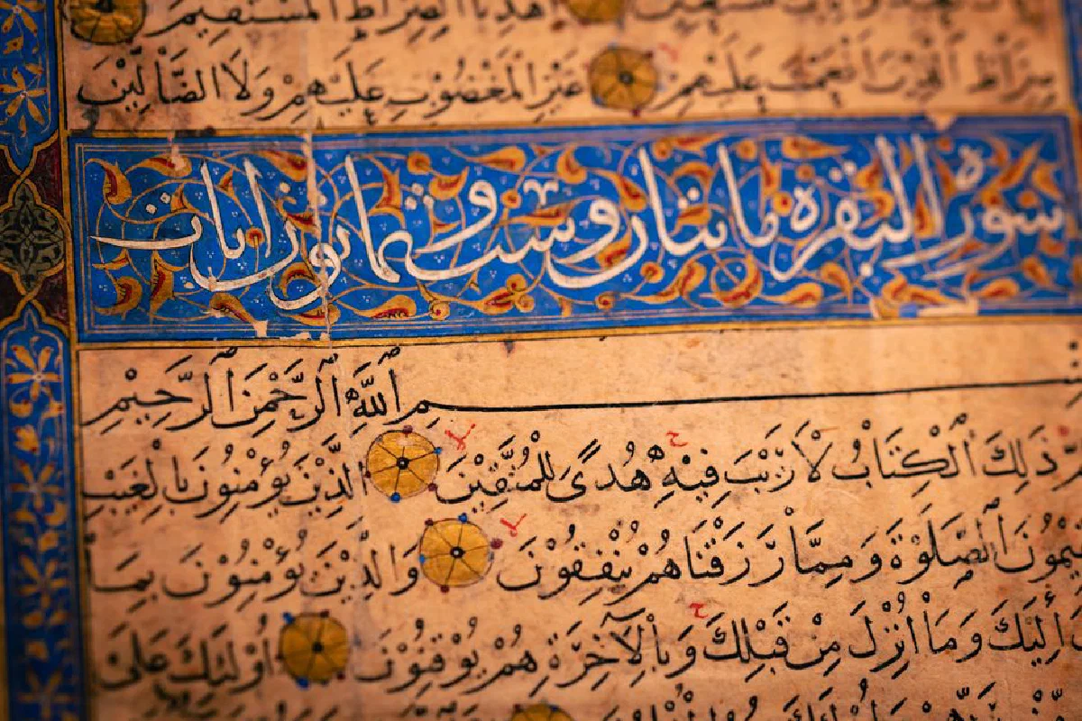 Close-up of an ancient manuscript featuring elaborate Arabic calligraphy and geometric designs.