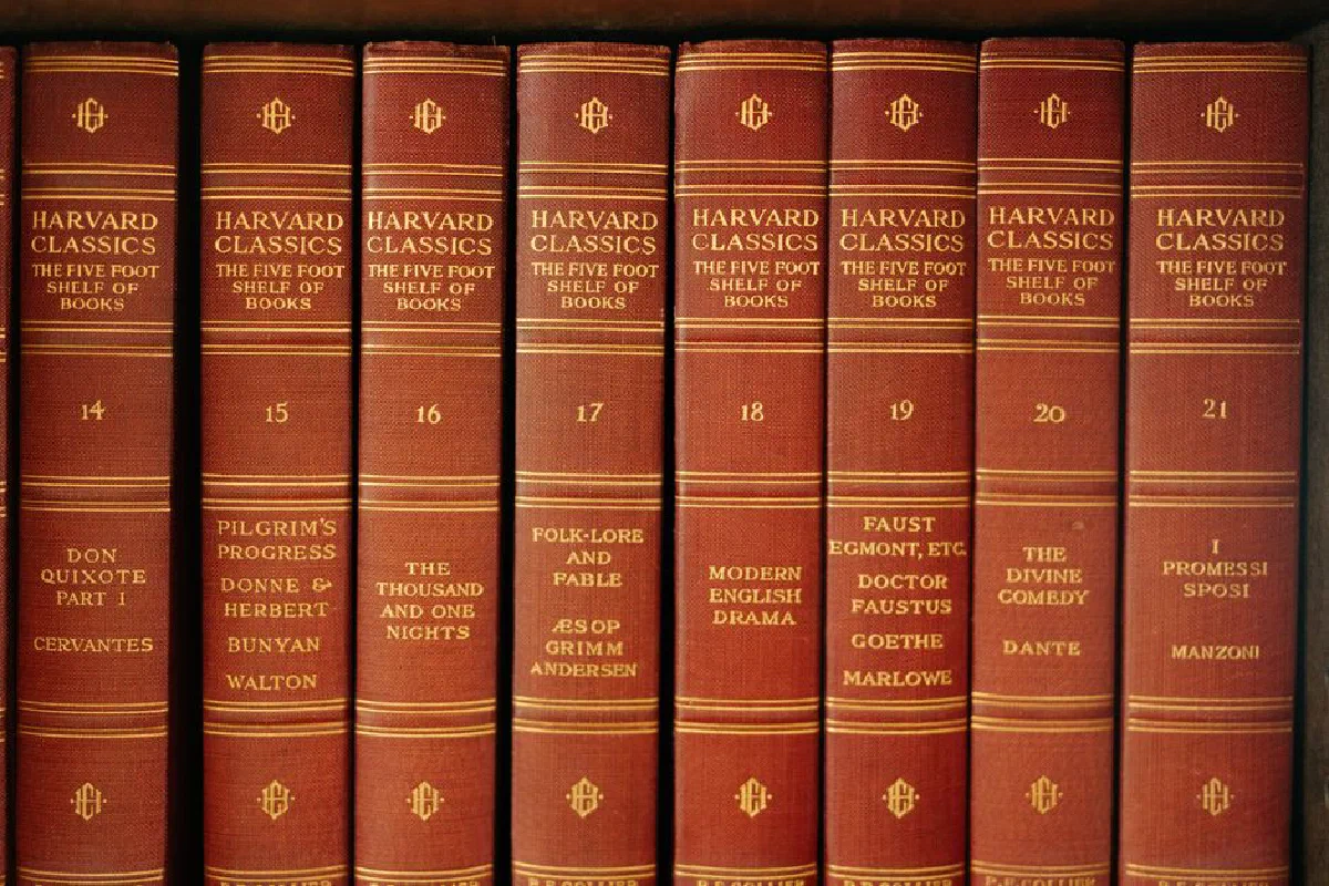 A row of classic literature volumes from the Harvard Classics series on a wooden shelf.