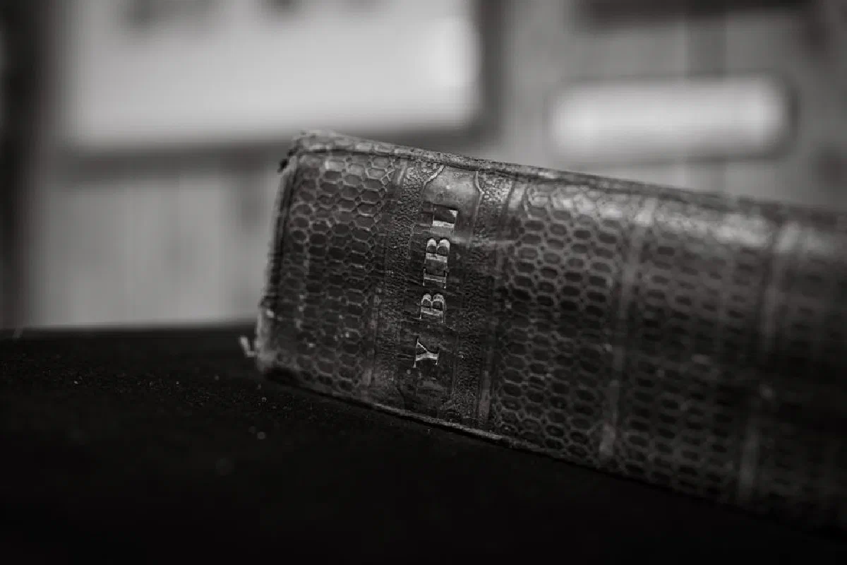 Close-up of a vintage leather-bound Bible in a black and white photograph, emphasizing religious heritage.