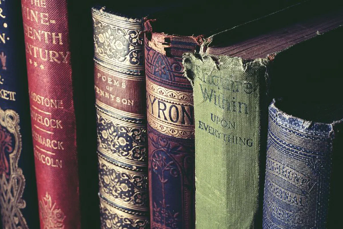 Close-up of vintage books with ornate covers, evoking knowledge and history.