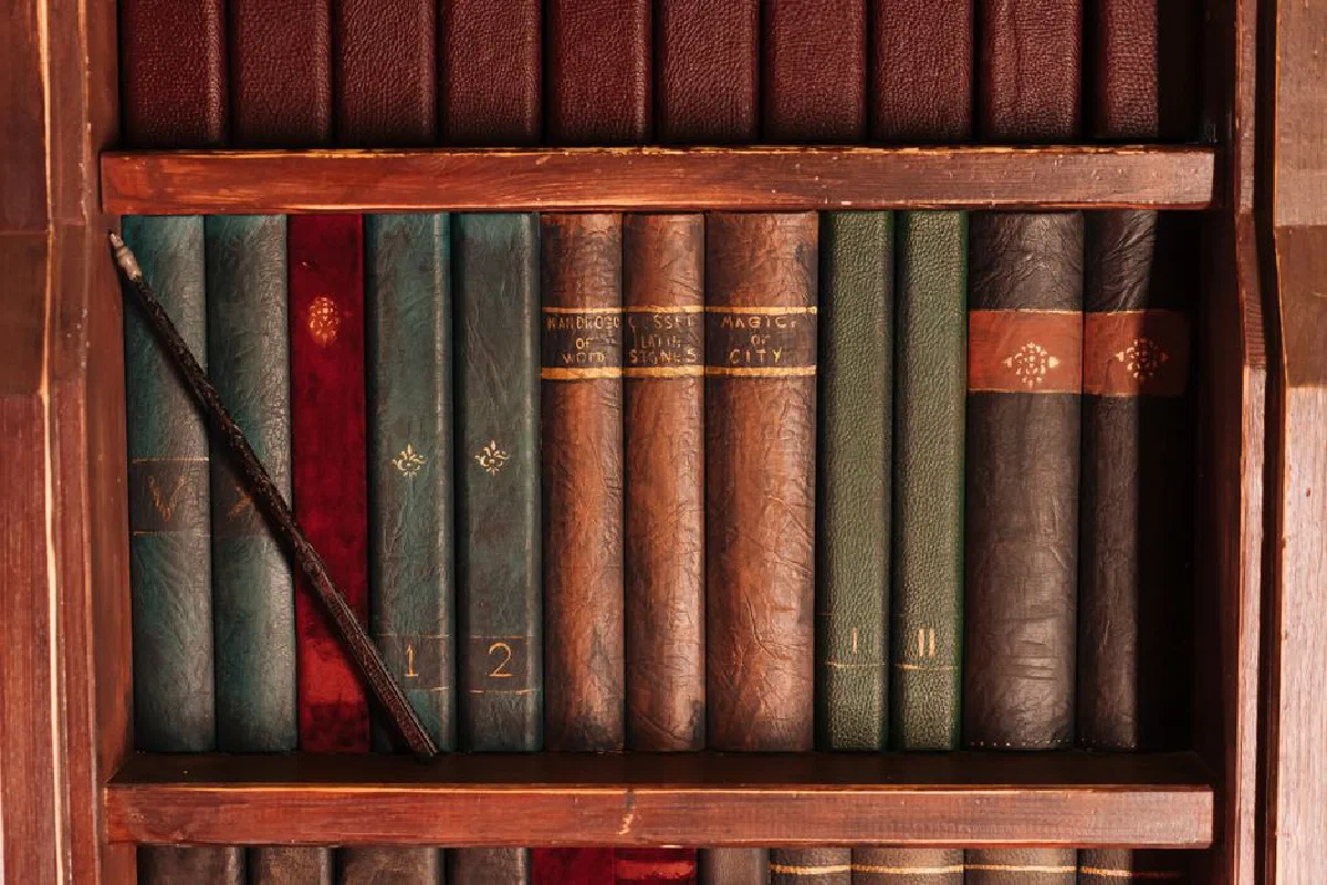 A close-up shot of a vintage bookshelf filled with leather-bound books.