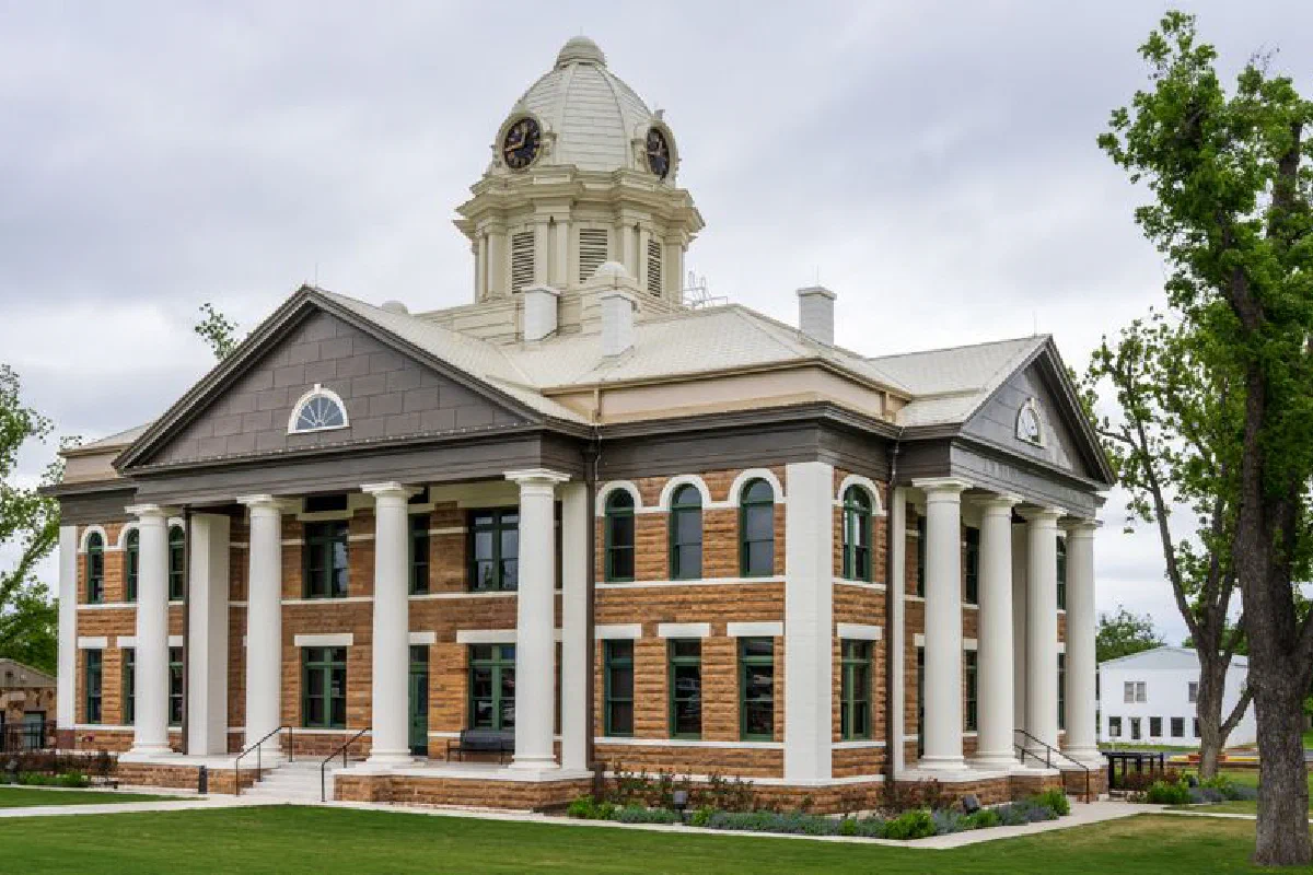 Elegant architecture of Mason County Courthouse in Texas against a cloudy sky.