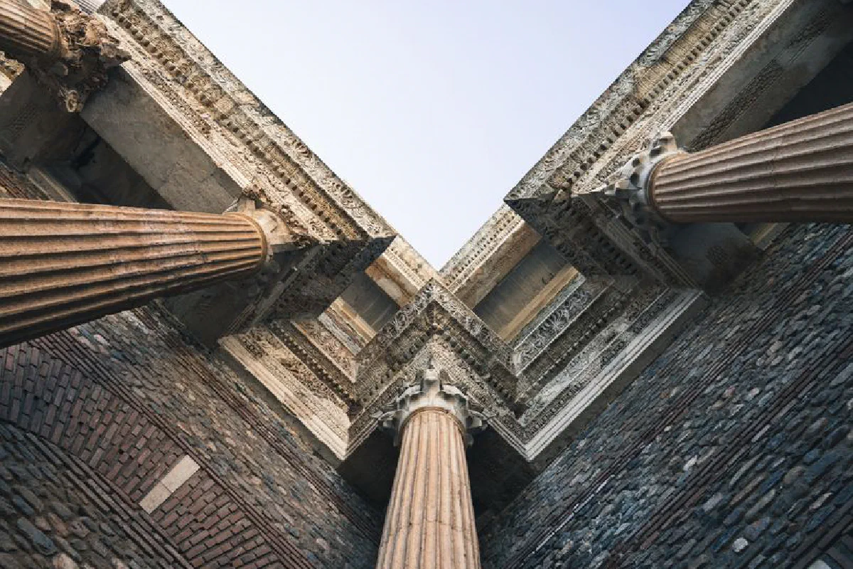 View looking up at the impressive ancient columns of Sardis Temple against a clear sky.