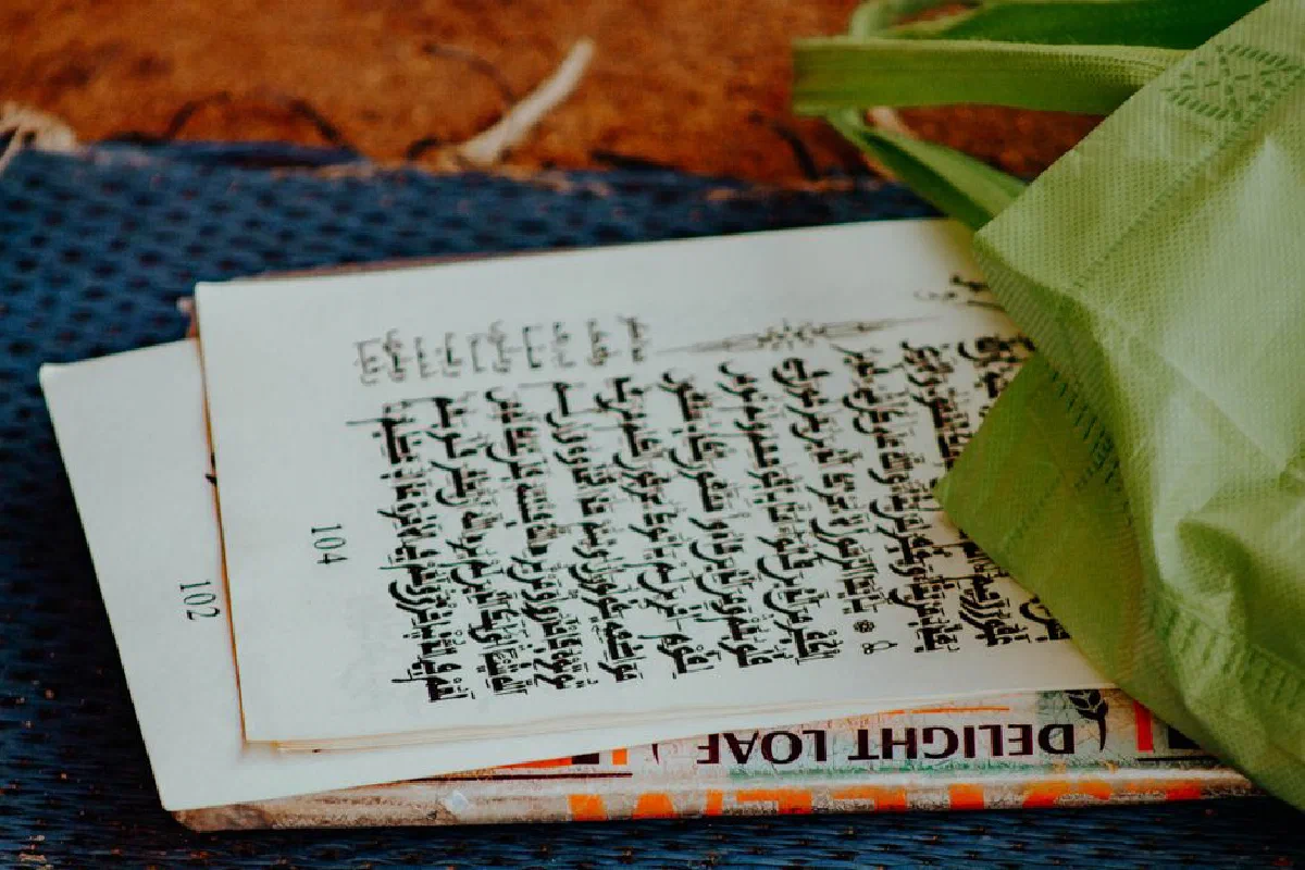 A detailed view of an old manuscript with a green bag, emphasizing vintage charm.