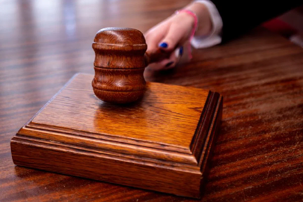 Close-up of a wooden judge's gavel on a desk in a courtroom, symbolizing justice.