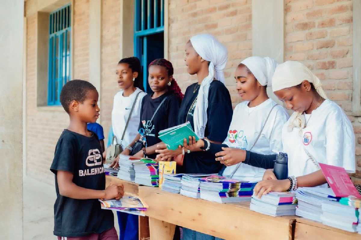 Engaged young adults distributing books at a community event. Bright and uplifting atmosphere.