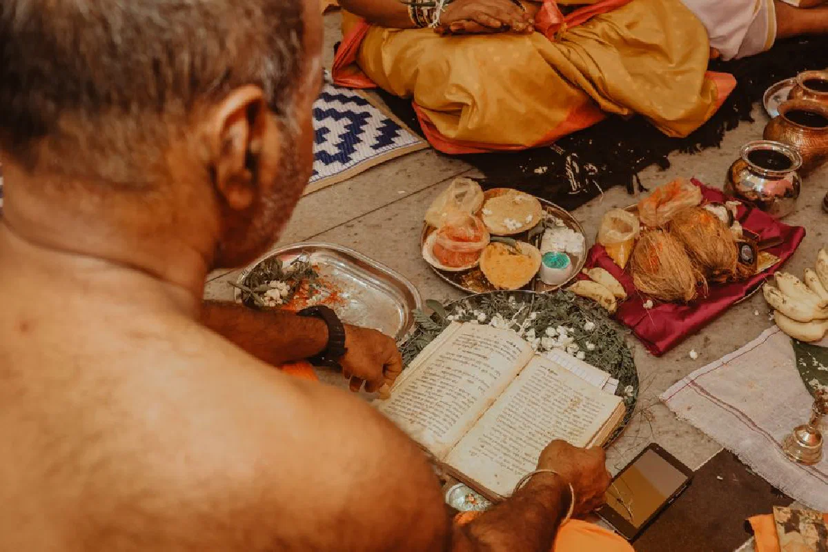 An intimate view of a traditional ceremony with ritual offerings and sacred texts.