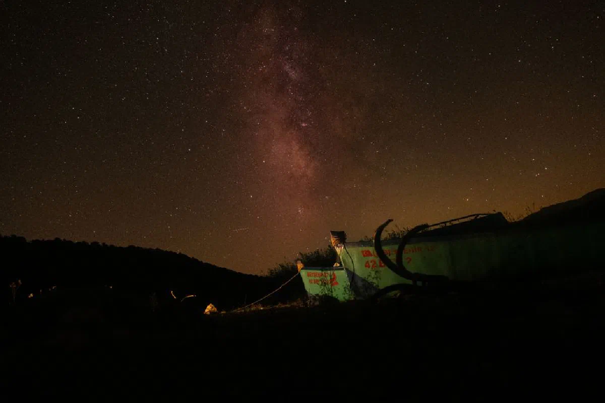 Captivating image of the Milky Way galaxy illuminating the night sky over a mountainous landscape.