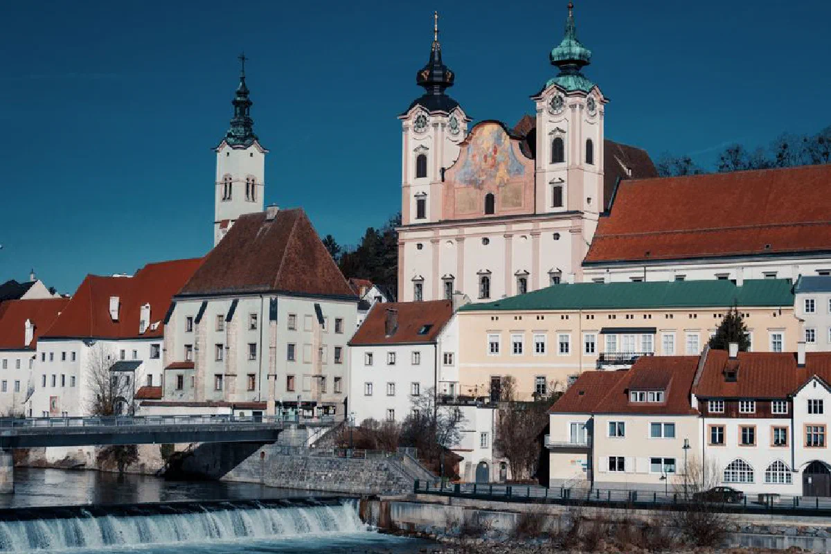 Scenic view of St. Michael's Church and river in Steyr, Austria.