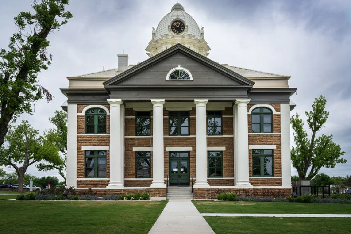 Classic architectural design of Mason County Courthouse, Texas amid lush greenery.