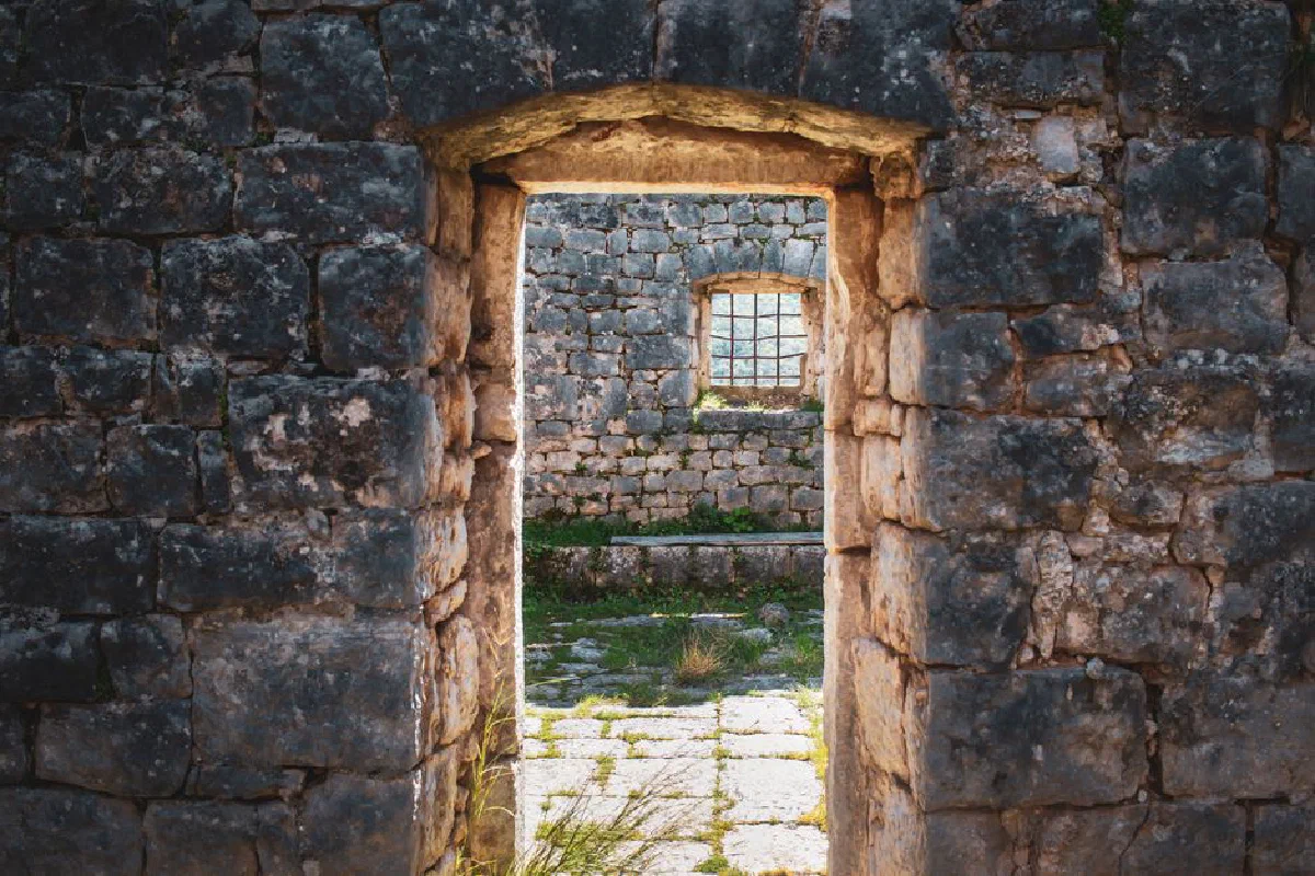 Explore the aged stone architecture of an abandoned castle ruin with a rustic entrance and window.